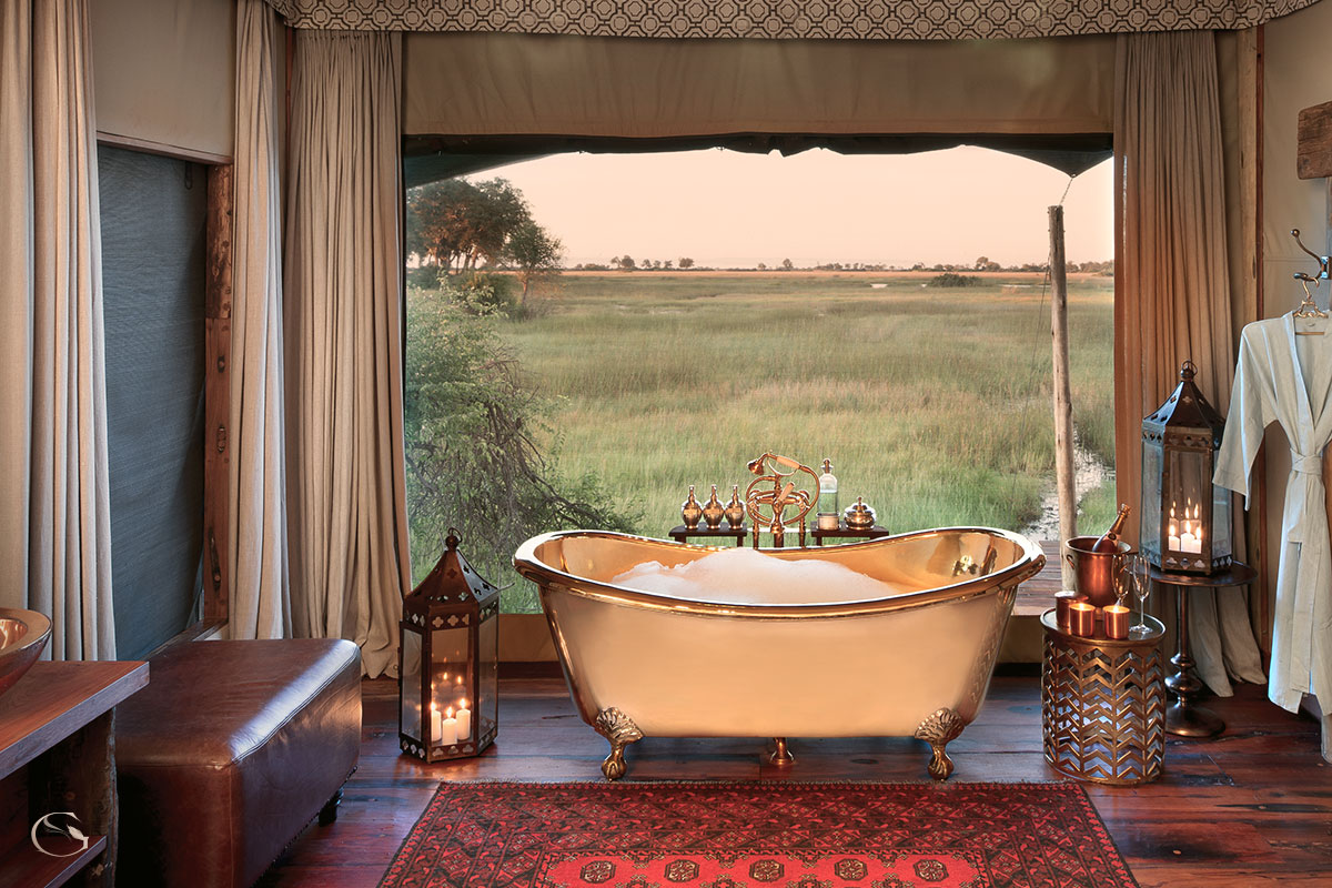 Deep soaking tubs with views of the wilderness at Duba Plains Suite